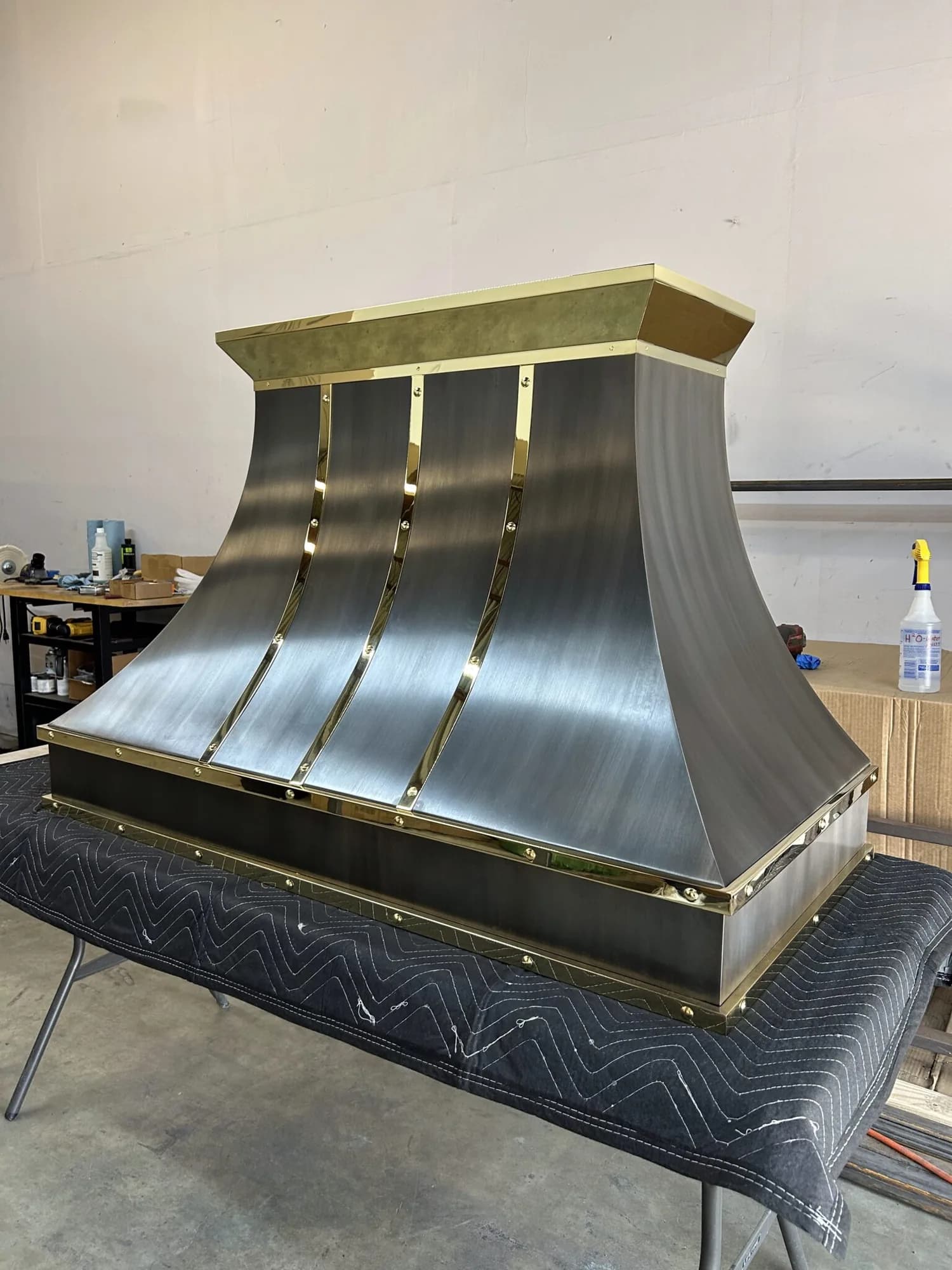 Monarch antiqued brushed stainless steel custom range hood, workshop view 1
