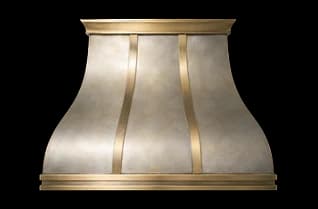 The Northport Luxe range hood in brushed steel with a honeycomb patina and brushed brass trim.