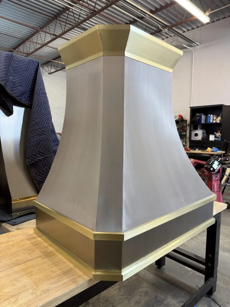 Brushed stainless steel Monarch range hood with brass straps, built for a New Jersey project and photographed at the Texas workshop before delivery — 9 of 12