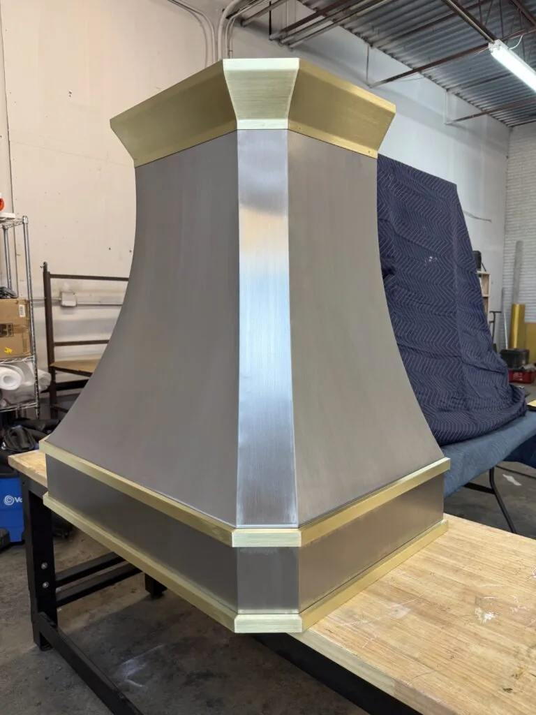 Brushed stainless steel Monarch range hood with brass straps, built for a New Jersey project and photographed at the Texas workshop before delivery — 12 of 12