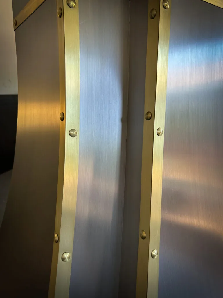 Brushed stainless steel Monarch range hood with brass straps, built for a New Jersey project and photographed at the Texas workshop before delivery — 2 of 12
