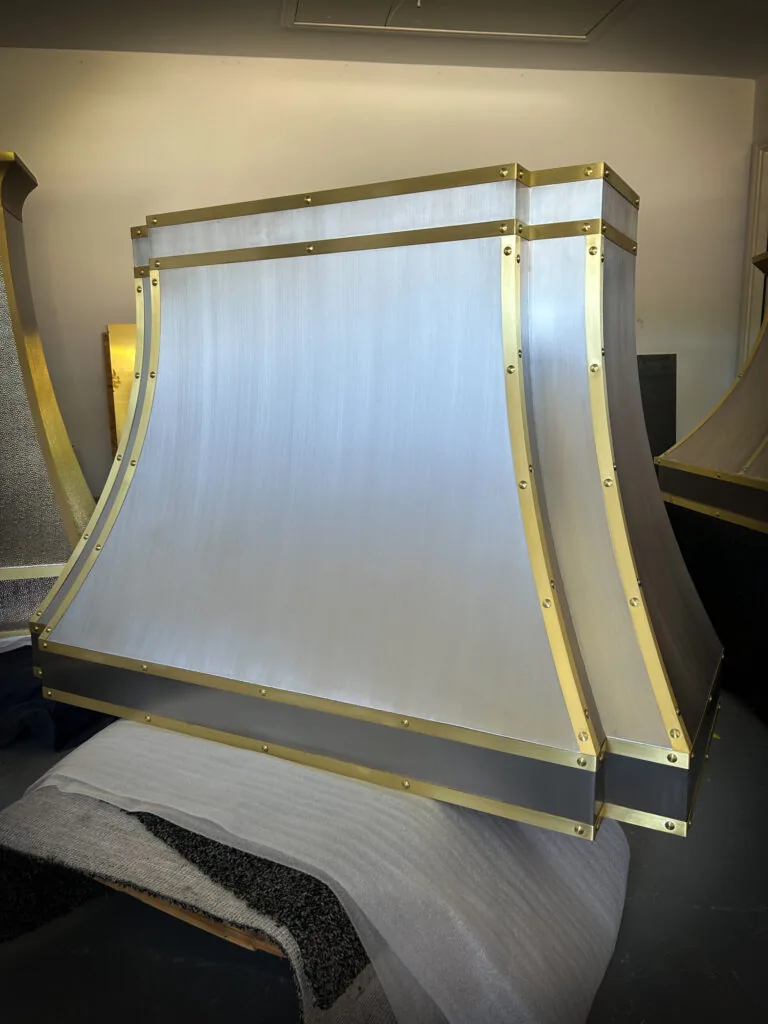 Brushed stainless steel Monarch range hood with brass straps, built for a New Jersey project and photographed at the Texas workshop before delivery — 3 of 12
