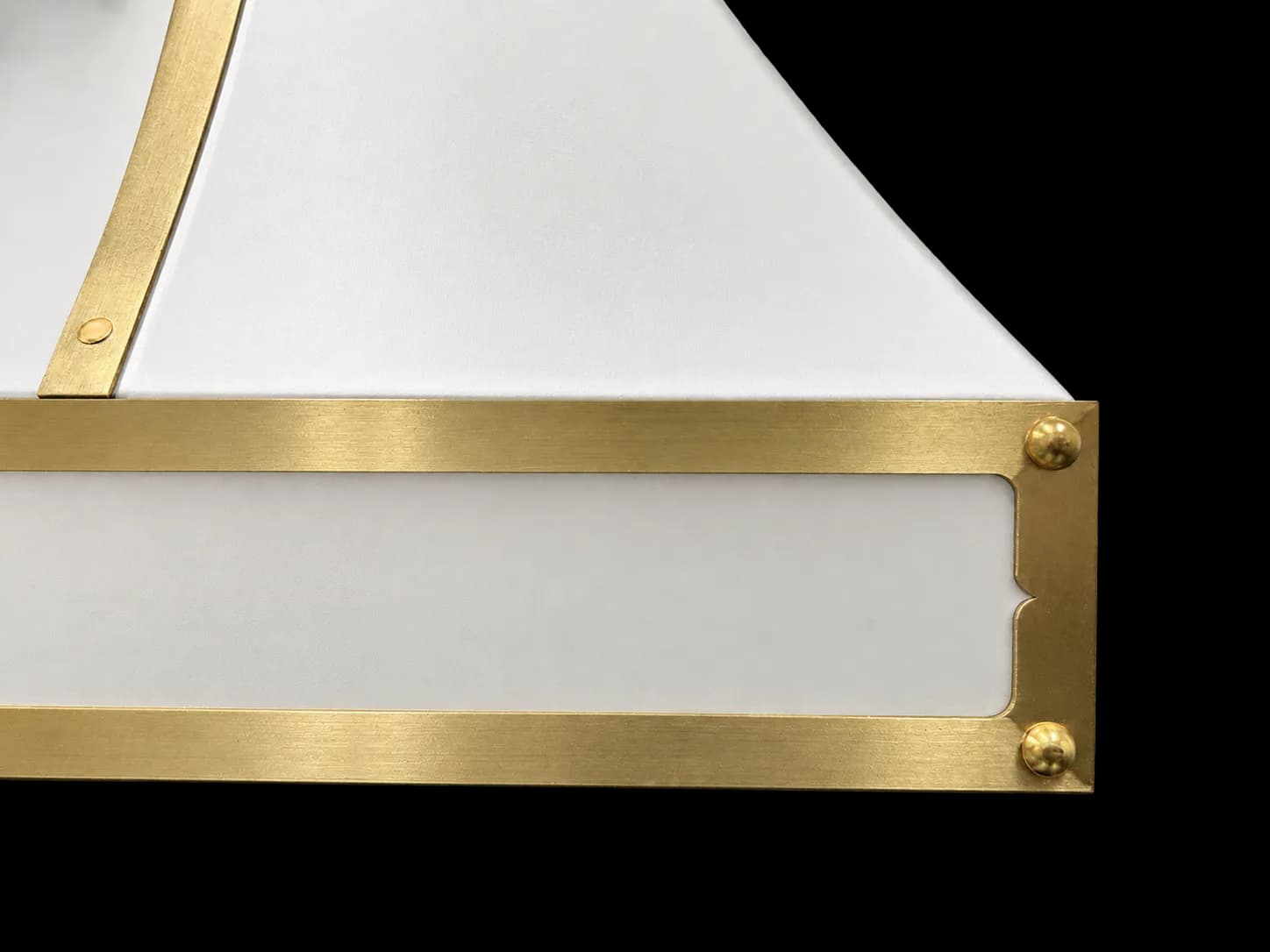 Close detail of the hood's one-inch brass strap, rivets and scalloped corner